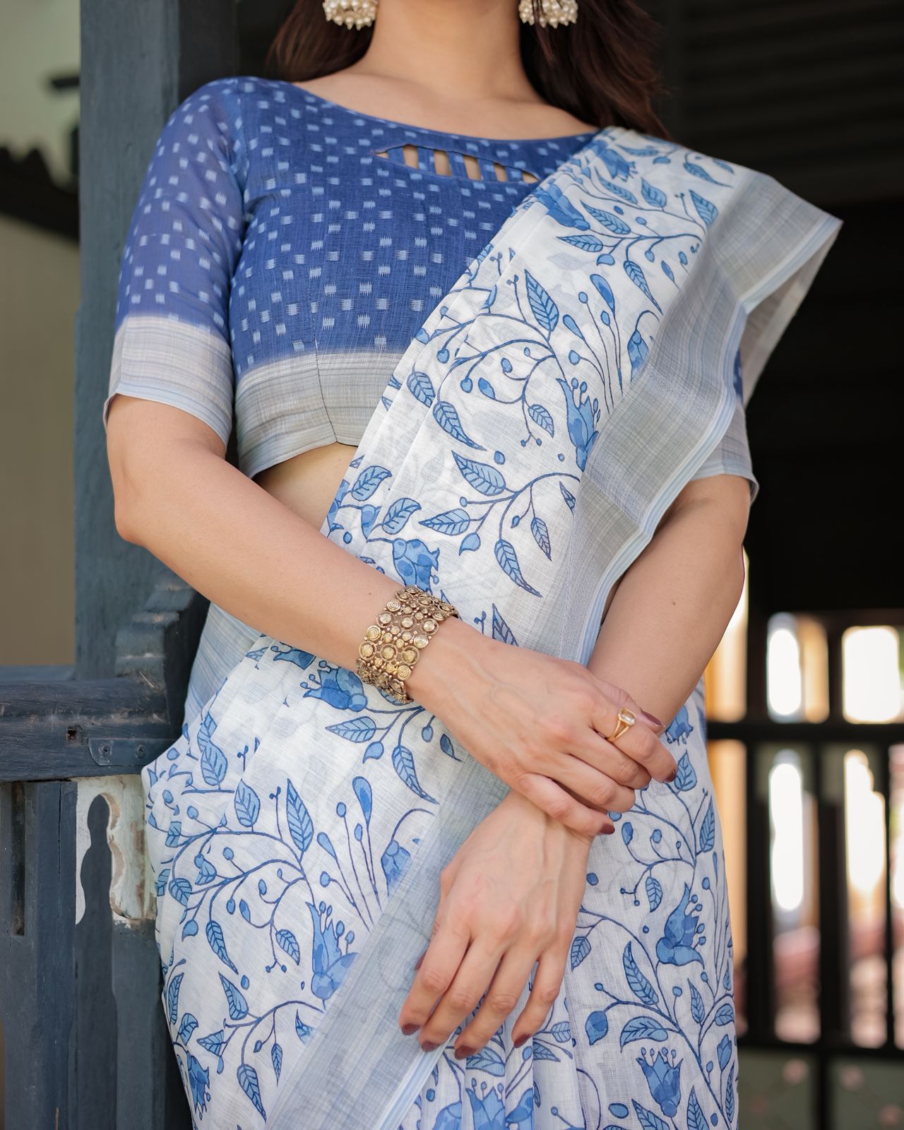 Elegant White Linen Saree with Blue Floral Design & Tassels
