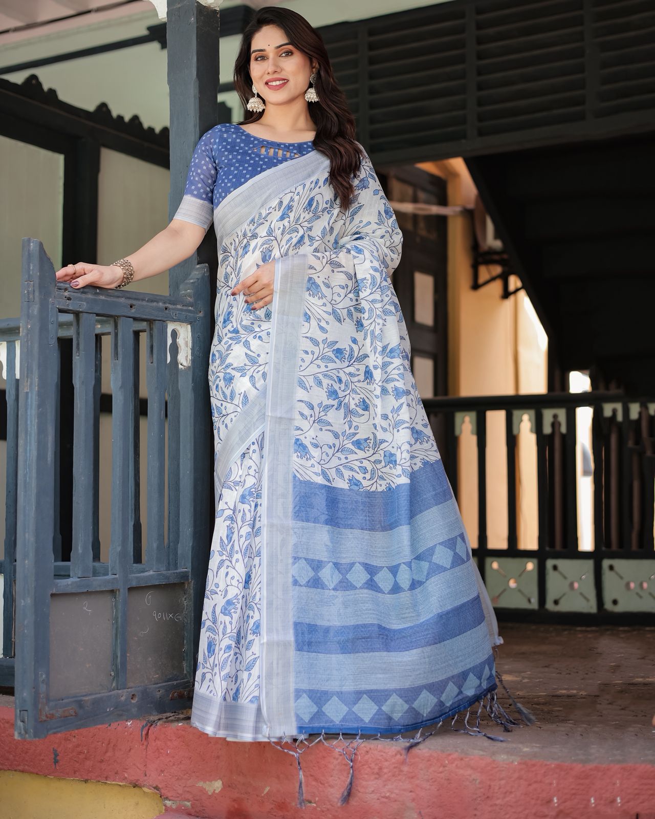 Elegant White Linen Saree with Blue Floral Design & Tassels