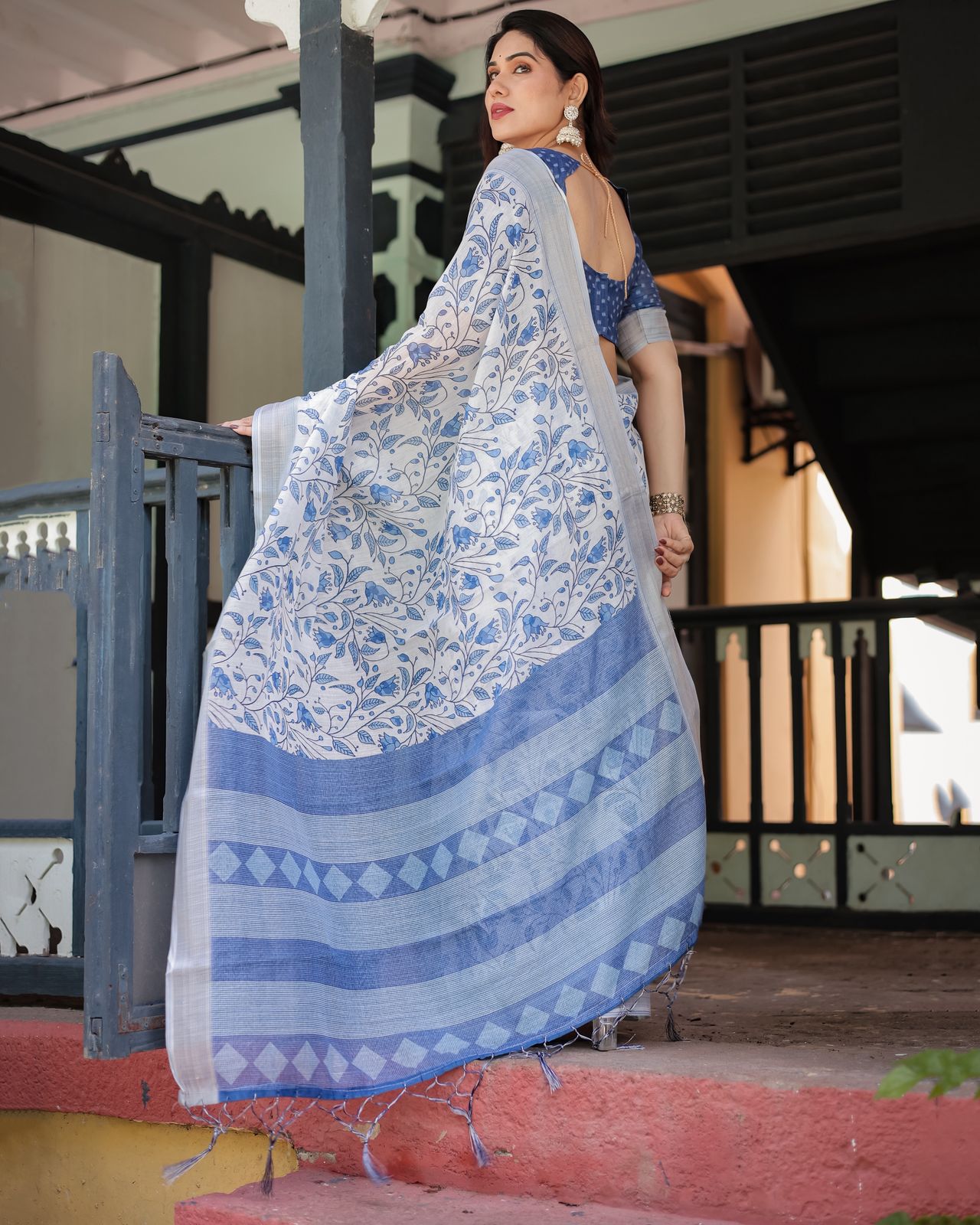Elegant White Linen Saree with Blue Floral Design & Tassels