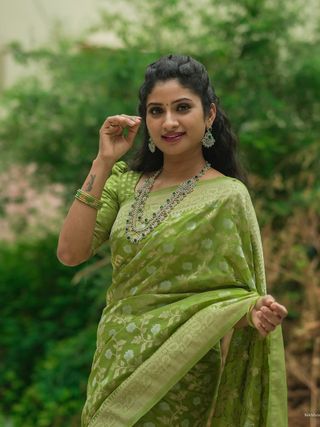 Festive Green Banarasi Saree with Subtle Zari Motifs
